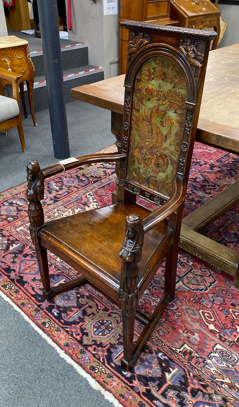 A 20th century carved mahogany cacqueteuse (armchair) with painted leather panelled back, width 54cm, depth 42cm, height 111cm